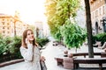 Happy smiling younng woman talking phone at city street. Petty businesswoman speaking mobile. Business lady call phone Royalty Free Stock Photo