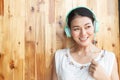 Happy smiling asian woman listening music by headphones Royalty Free Stock Photo