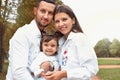 Happy smilling little girl with her parents in the park Royalty Free Stock Photo