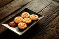 Happy snack with Chicken nugget with smile tomato sauce in black plate on rough wooden Royalty Free Stock Photo