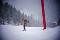 Happy snowboarder waving his arms on Alpine skiing slope russia