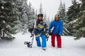 Happy snowboarders relax on the mountain slope