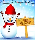 Happy Snowman Character With Hello Winter Greeting in Wood Sign in Snow Background Royalty Free Stock Photo