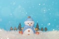 Happy snowman standing in blue winter christmas snow background. Christmas landscape with gifts and snow. Merry christmas and happ Royalty Free Stock Photo