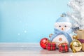 Happy snowman standing in blue winter christmas snow background. Royalty Free Stock Photo