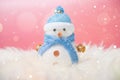 Happy snowman standing in blue winter christmas snow background. Royalty Free Stock Photo