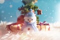 Happy snowman standing in blue winter christmas snow background. Merry christmas and happy new year greeting card with copy-space. Royalty Free Stock Photo
