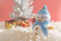 Happy snowman standing in blue winter christmas snow background. Royalty Free Stock Photo