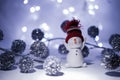 Happy snowman standing in a snowy winter night. Happy snowman standing in a winter Christmas landscape. Merry christmas and happy Royalty Free Stock Photo