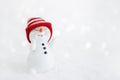 Happy snowman standing in winter christmas landscape. Merry christmas and happy new year greeting card. Funny snowman in hat on Royalty Free Stock Photo