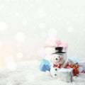 Happy snowman with xmas presents on sunny winter day. Royalty Free Stock Photo