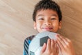 Happy Soccer Boy lying on floor holding a soccer ball with copy space Royalty Free Stock Photo