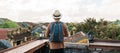 Happy solo traveler traveling at Hoi An ancient town in Vietnam, man with backpack sightseeing view at rooftop.landmark and Royalty Free Stock Photo