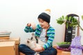 Happy son and a cat having fun together at moving day in new home. Family moves into a new apartment Royalty Free Stock Photo