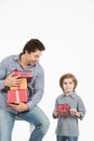 Happy son hugging his father and gives him gift. Fathers day, family holiday. Royalty Free Stock Photo