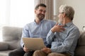 Happy son and old father having fun, using laptop together Royalty Free Stock Photo