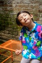 Happy Southeast Asian ethnicity little boy having fun sunbathing in the morning at the backyard