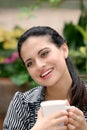 Happy spanish woman drinking coffee