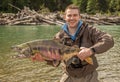A happy sport fisherman holding up a big trophy Chum Salmon Royalty Free Stock Photo