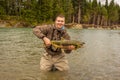 A happy sport fisherman proudly holding up his catch of a Chum Salmon Royalty Free Stock Photo