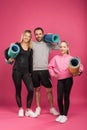 happy sportive family holding fitness mats, isolated