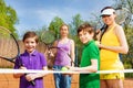Happy sportive family with tennis apparel