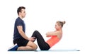 Happy sportive man and woman doing sit-ups