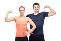 Happy sportive man and woman showing biceps power Royalty Free Stock Photo