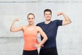 Happy sportive man and woman showing biceps power Royalty Free Stock Photo