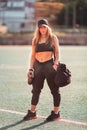 Happy sportive woman standing on a stadium field Royalty Free Stock Photo