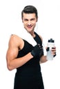 Happy sports man holding towel and bottle with water Royalty Free Stock Photo