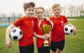 Happy Sports Soccer Team Players Holding Trophy. Winners of Youth Football Tournament Royalty Free Stock Photo