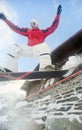 Happy sportsman with snowboard in motion