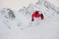 Happy sportsman with snowboard in motion