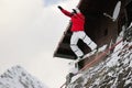 Happy sportsman with snowboard in motion