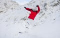 Happy sportsman with snowboard in motion