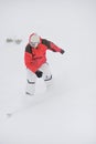 Happy sportsman with snowboard in motion