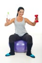 Happy sportswoman giving water and barbell