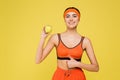 happy sportswoman holding green apple and