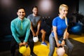 Young sporty people working out together with kettle bells in a gym. Royalty Free Stock Photo