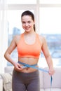 Happy sporty woman measuring her waist with tape Royalty Free Stock Photo