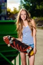 Happy sporty woman with skateboard