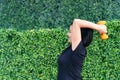 Happy sporty woman training arm muscles lifting weights and looking into the distance in the park. Healthy lifestyle. Fitness, Royalty Free Stock Photo