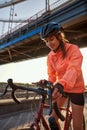 Happy sporty woman use smartphone ride bike
