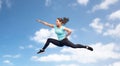Happy sporty young woman jumping in fighting pose Royalty Free Stock Photo