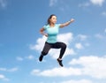 Happy sporty young woman jumping in fighting pose Royalty Free Stock Photo