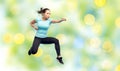 Happy sporty young woman jumping in fighting pose Royalty Free Stock Photo