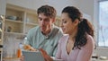 Happy spouses breakfasting tablet at kitchen closeup. Couple looking computer Royalty Free Stock Photo