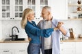 Happy Spouses. Loving Senior Husband And Wife Dancing In Kitchen Interior Royalty Free Stock Photo