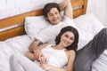 Happy spouses relaxing in bed and enjoying closeness Royalty Free Stock Photo